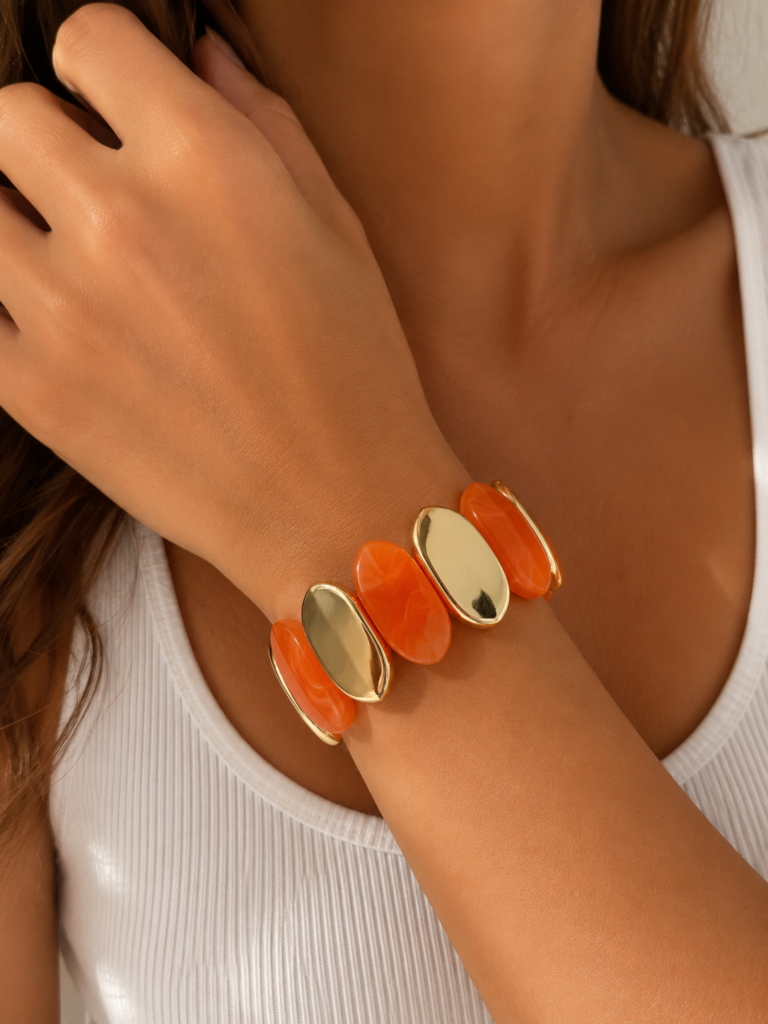 Pulsera elástica naranja y dorada